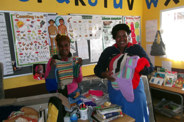 The teachers with the knitwear before giving them to the children