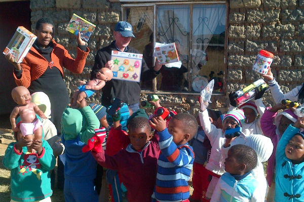 Children at Siblisisie school receiving their toys and puzzles