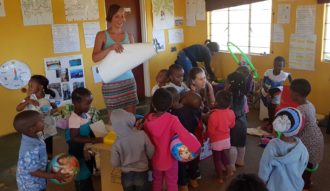 Typhaine and Anke issuing toys at Sbusisiwe