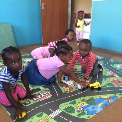 Children enjoying the new play mats sponsored by Georg and Gertrud.