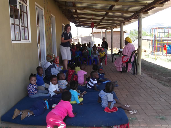 Gogo (Grandmother) reading to some of the Siqalakuhle children